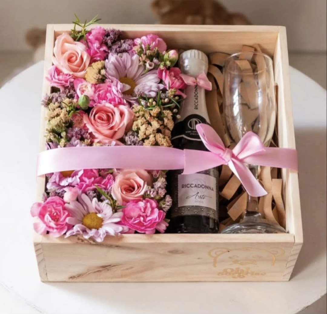 Pink floral gift box with a champagne bottle and two glasses