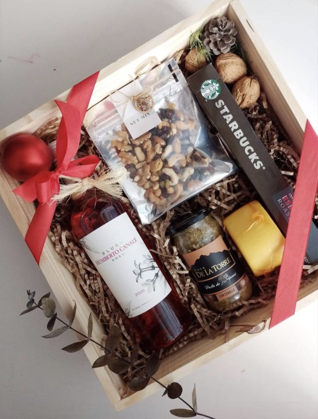 Savor and Toast - A bottle of wine, cheese, pistachios, walnuts, and jam.