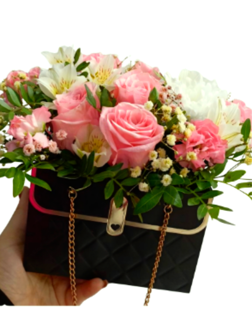 The Empress Purse Arrangement  - A stunning blend of fashion and floral art. This chic, black quilted purse-style box overflows with premium pink roses, delicate alstroemerias, and fresh white blooms.