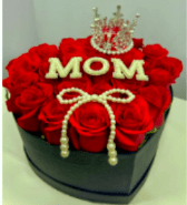 Royal Mother - An elegant, premium heart-shaped box filled with fresh, high-quality red roses. This sophisticated arrangement features a delicate pearl bow, a shimmering rhinestone "MOM" centerpiece, and is beautifully crowned with a silver tiara. The ultimate luxury gift to celebrate the queen of your heart.