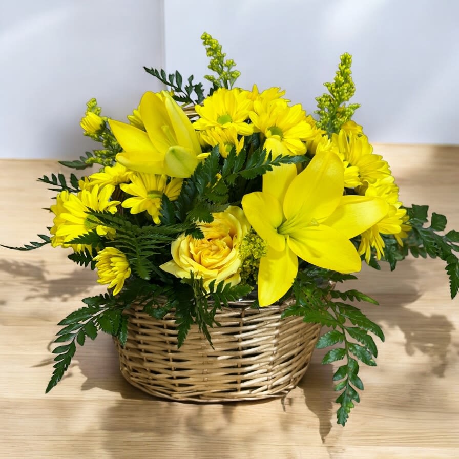 Yellow floral arrangement in a wicker basket
