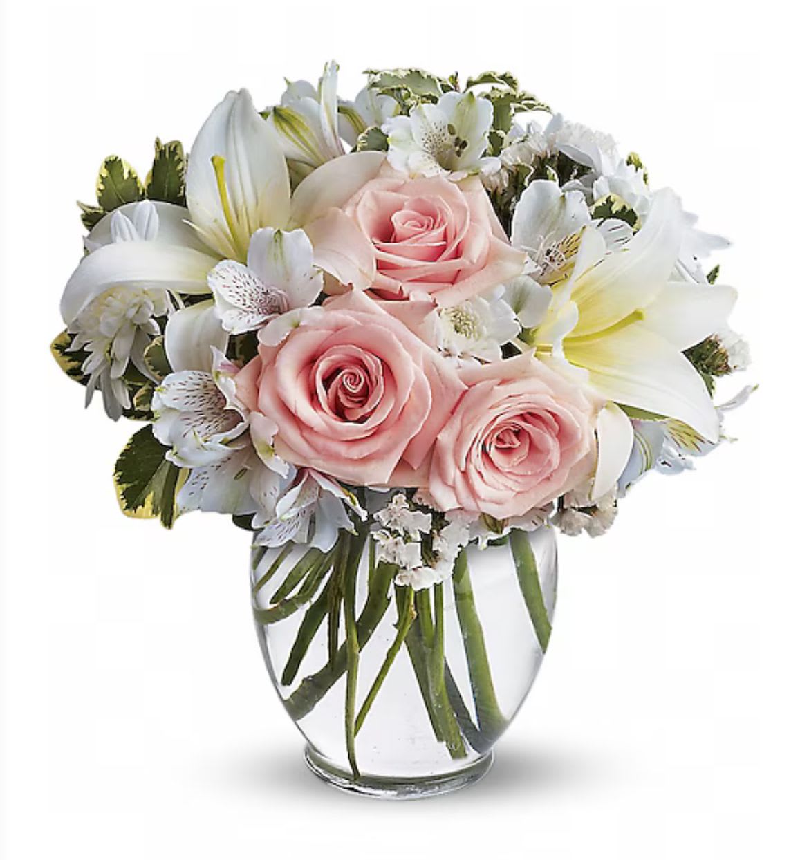 Compact arrangement of pink roses and white lilies in a clear glass vase