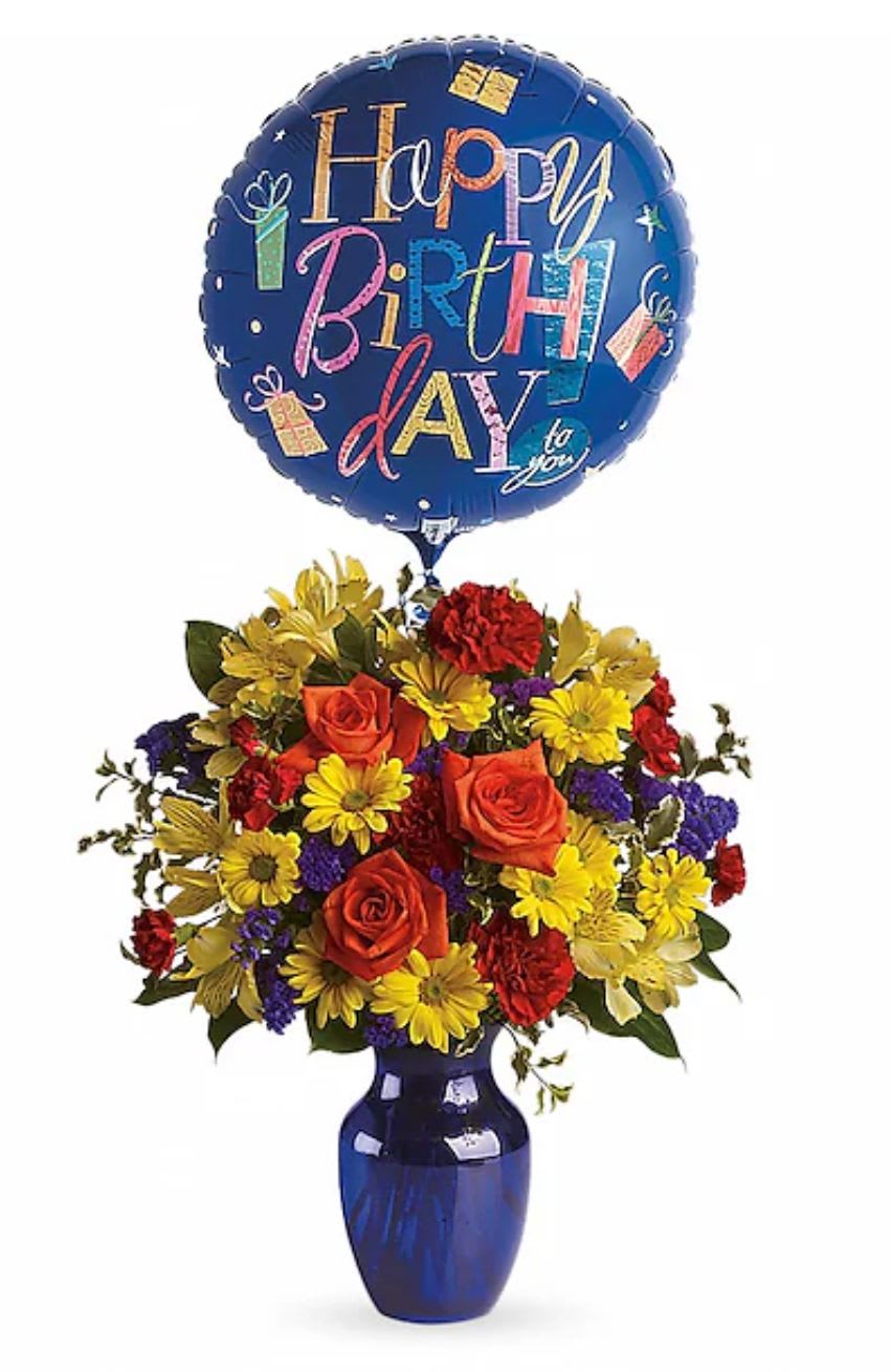 Birthday balloon above a colorful flower arrangement in a blue vase