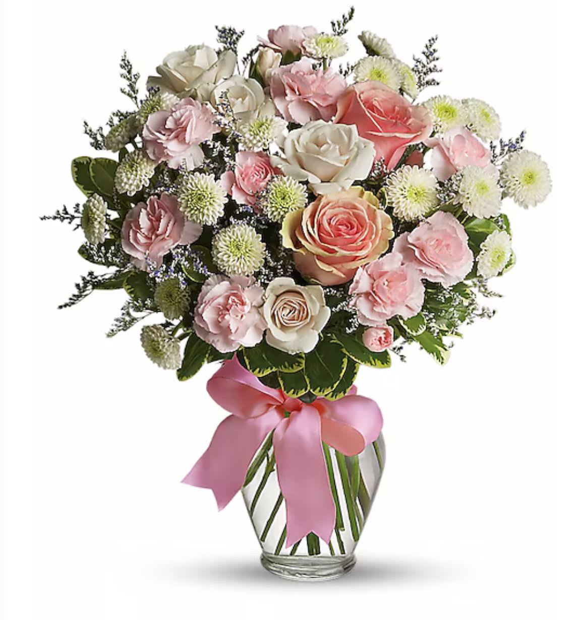 Bouquet of pink and white roses and carnations in a glass vase with a pink ribbon bow