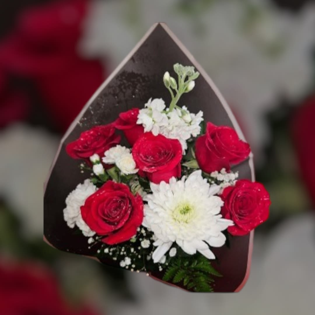 Bouquet of red roses and white daisies in dark wrapping