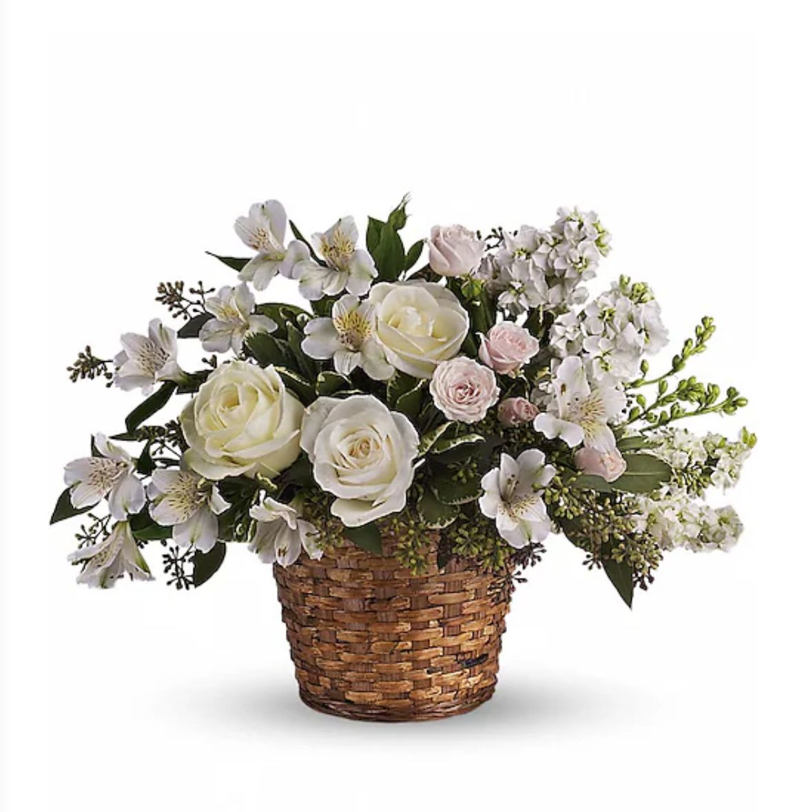 White and pale pink roses with white alstroemeria arranged in a woven basket.