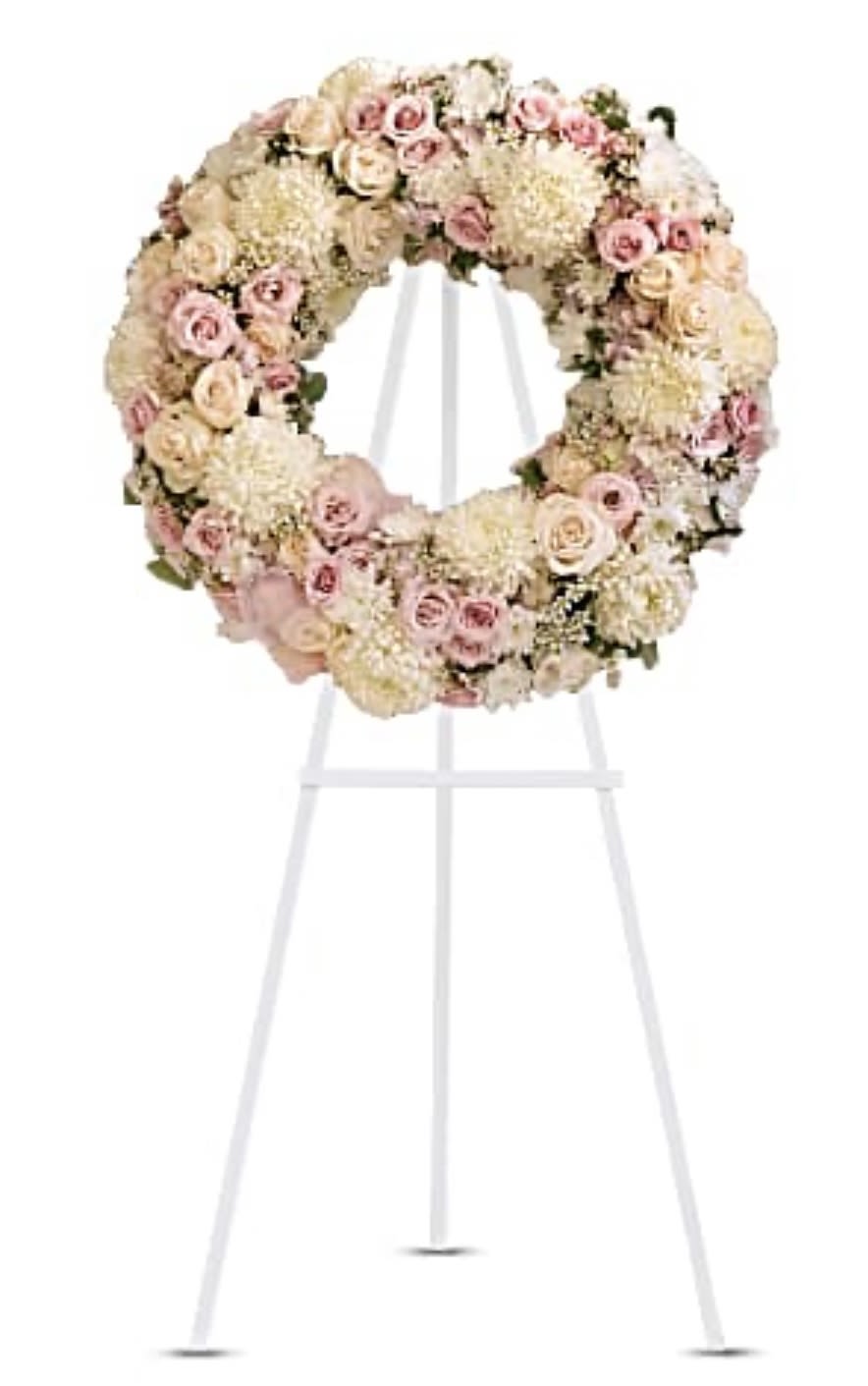 Pastel floral wreath on a white stand