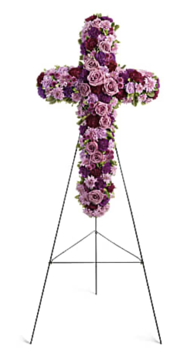 Purple and pink floral cross on a metal stand