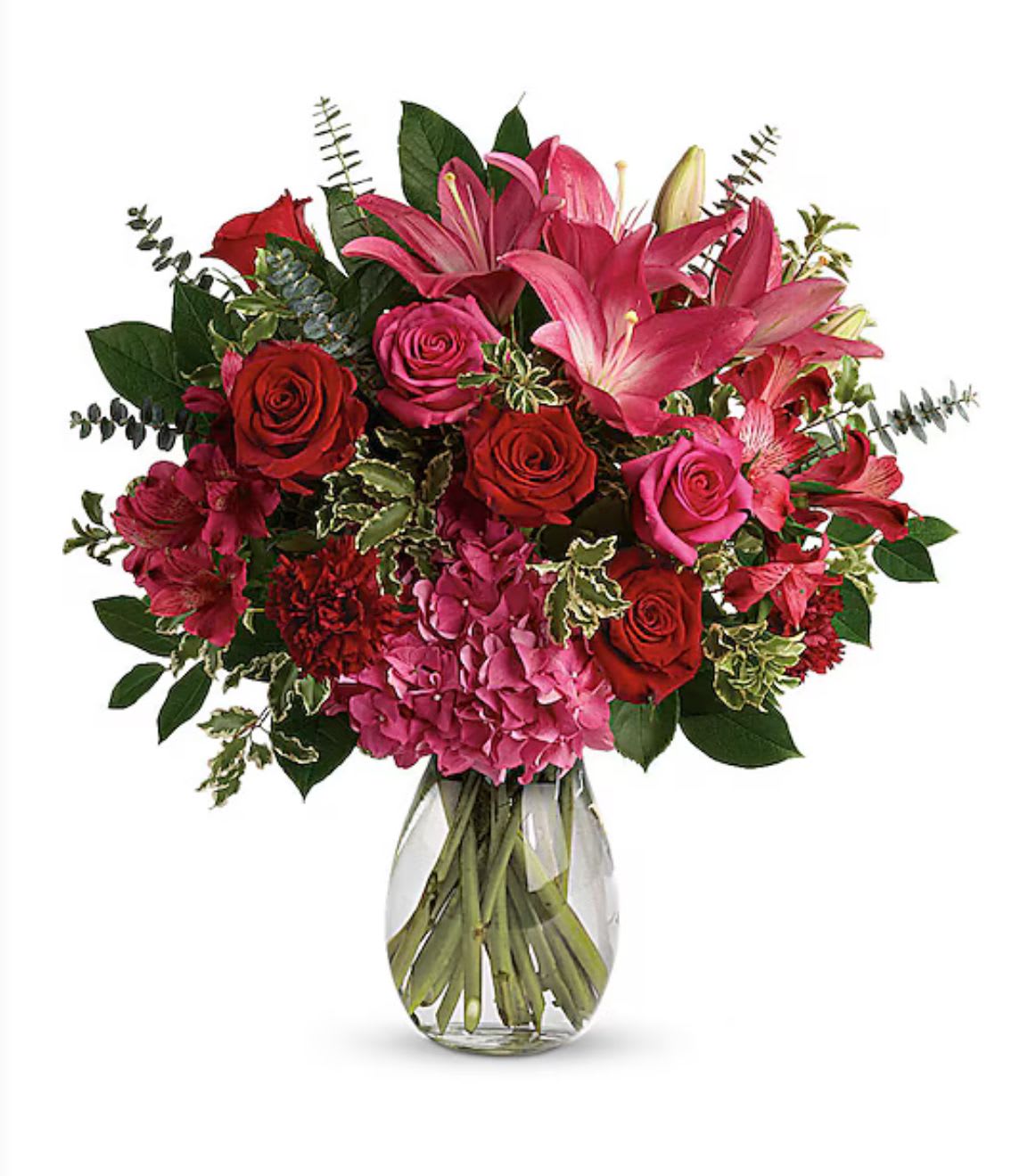 Bouquet of pink lilies, red and pink roses in a glass vase