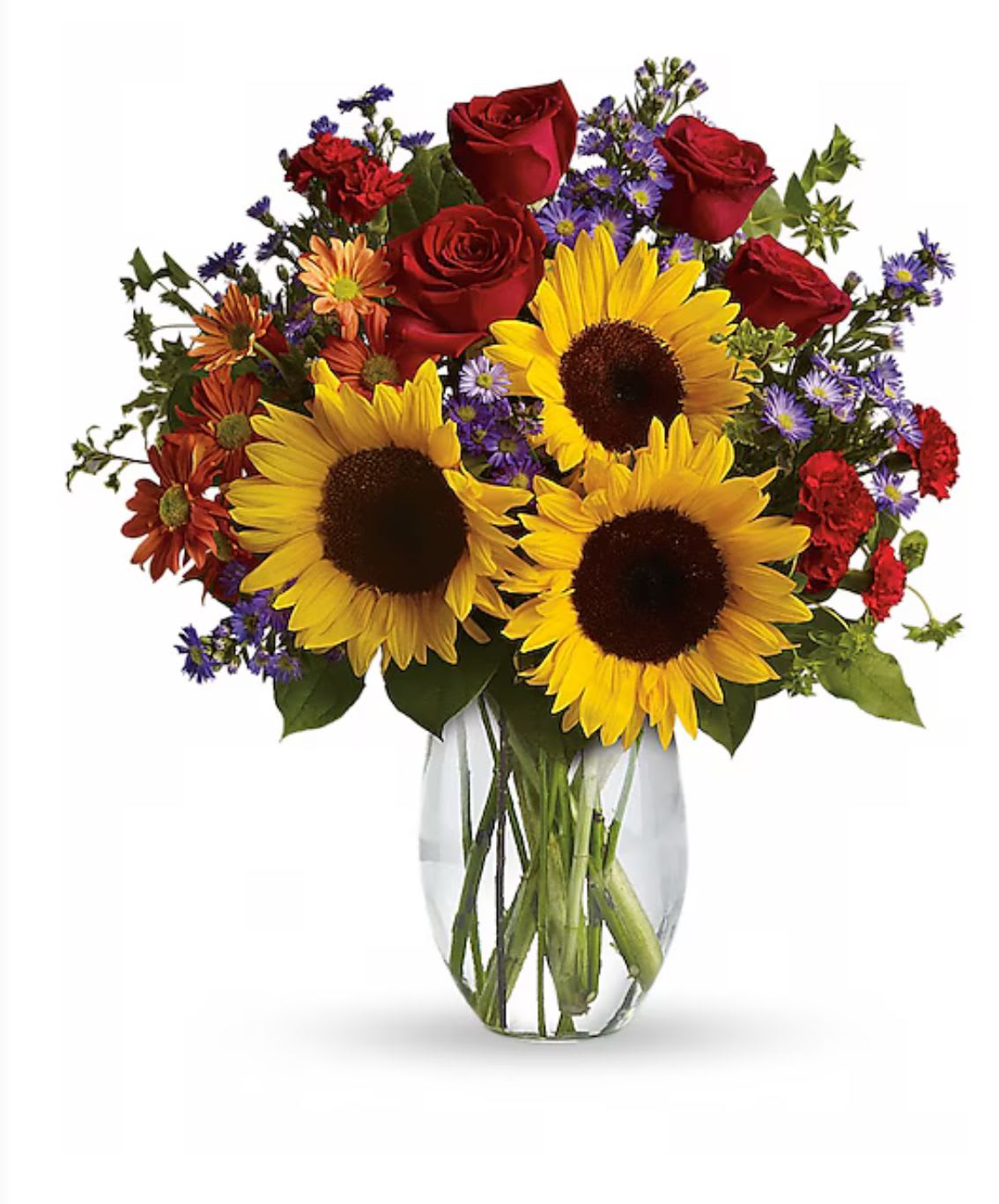 Bouquet of sunflowers, red roses, and purple daisies in a clear glass vase