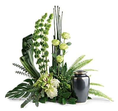 Green floral arrangement with a black urn