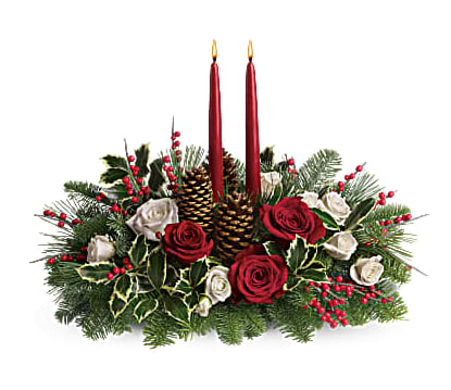 Holiday centerpiece with red candles, roses, pinecones, and evergreen branches