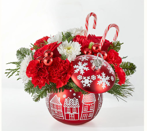 Christmas arrangement in a red ornament vase with candy canes and snowflake decorations