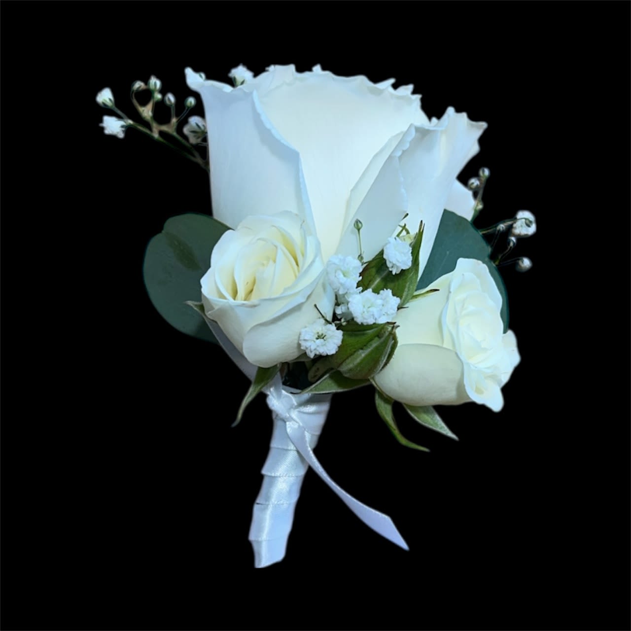 Pure Elegance Groom Boutonniere - A sophisticated groom’s boutonniere featuring a single white rose paired with two spray roses, accented with delicate baby’s breath and silver dollar eucalyptus. Finished with a white ribbon, this classic design exudes timeless elegance—perfect for formal or romantic weddings.