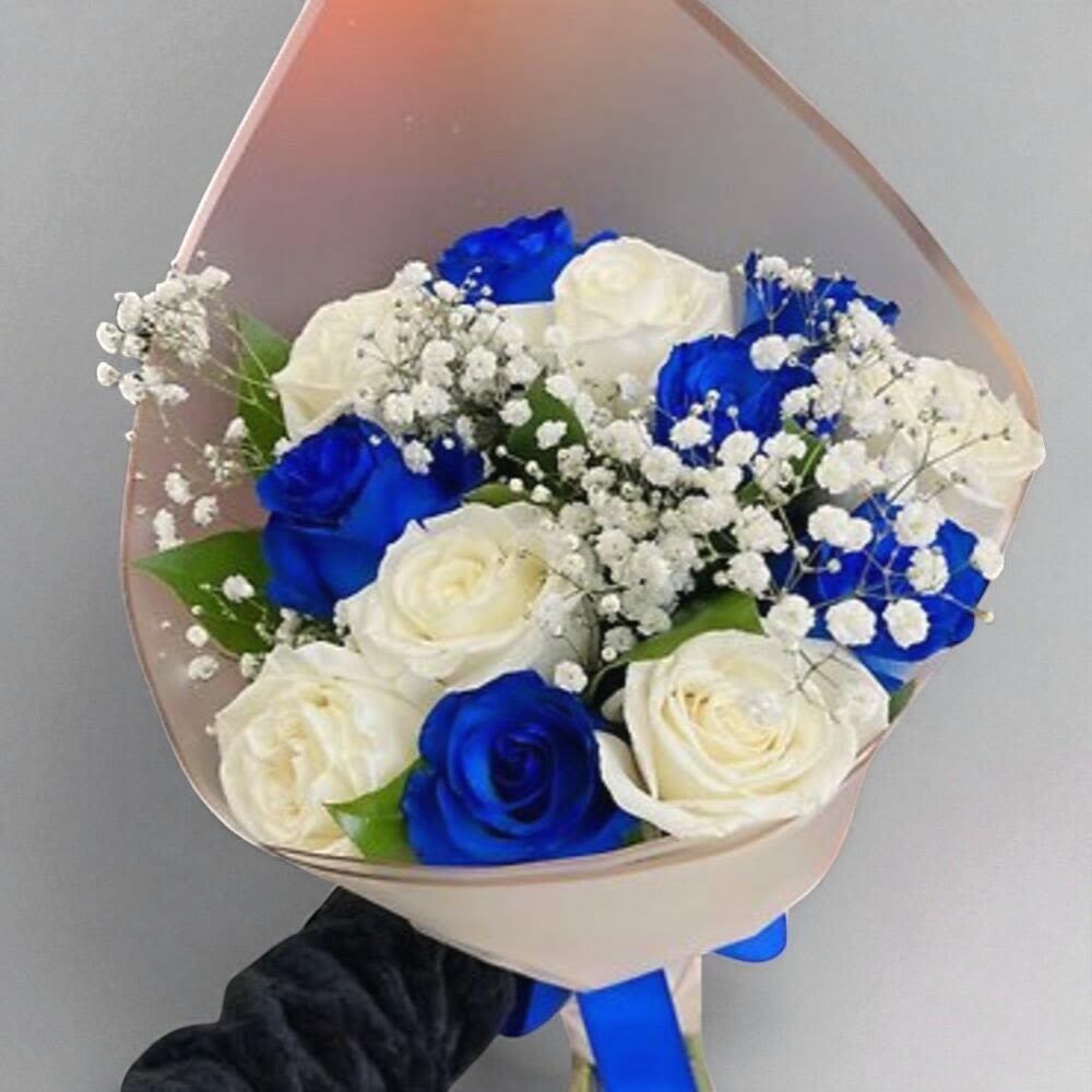 Bouquet of blue and white roses with baby's breath in pale wrap