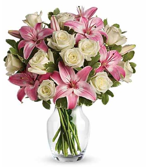 Always a Lady - She'll always be your #1 lady. Remind her just how special she is - send a sensational gift she'll never forget. This beautiful bouquet of fragrant pink lilies and lush white roses is sure to make an impression! - Seventeen white roses are mixed with pink asiatic lilies and variegated pittosporum in a classic clear glass rose vase. - Orientation: All-Around-
