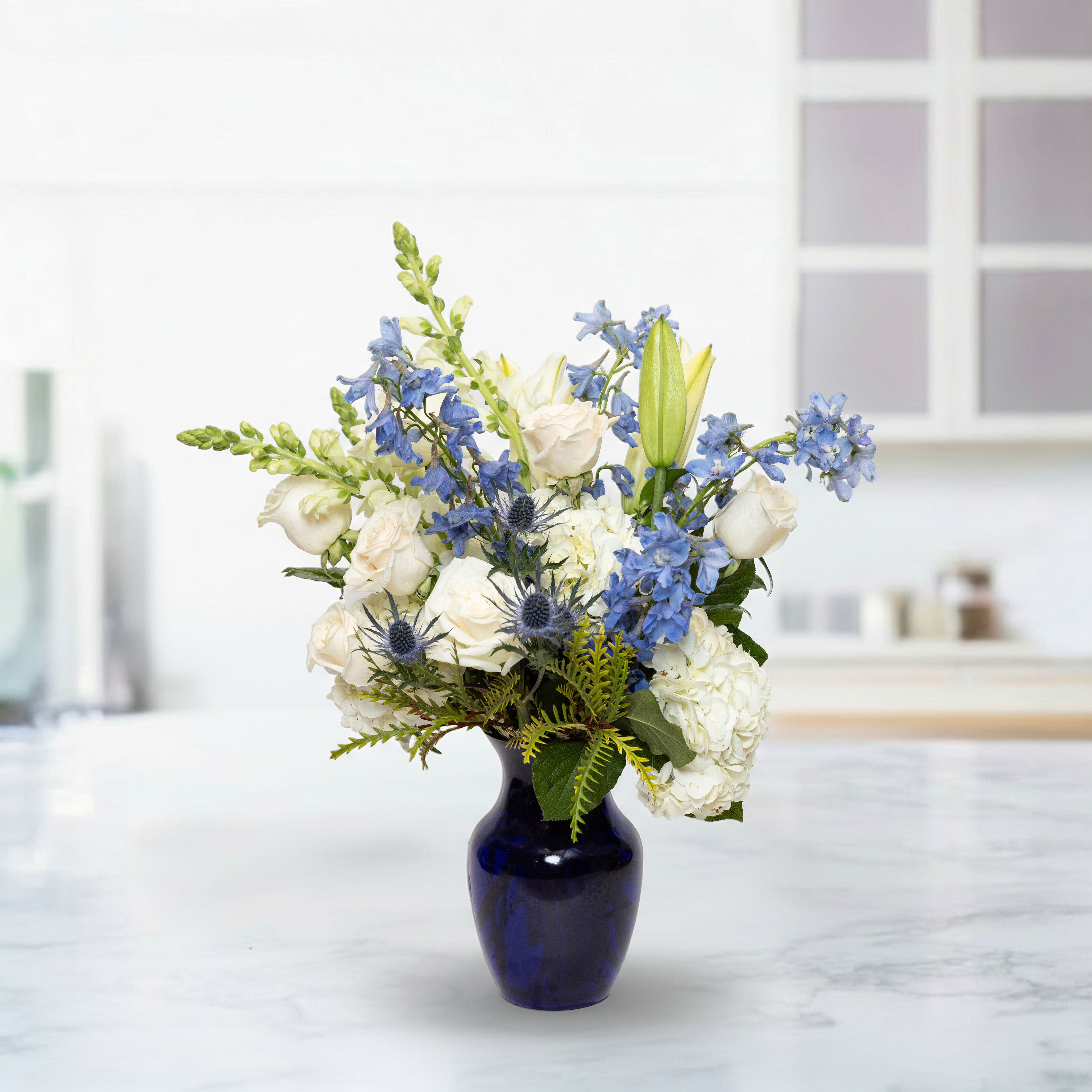 Blue Harmony - Blue Harmony is a beautiful floral arrangement featuring a serene blend of blue and white blooms complemented with lush greenery. Perfect for weddings, anniversaries, birthdays, sympathy flowers, or special occasions, this bouquet radiates elegance, tranquility, and timeless beauty. Its carefully selected flowers create a sophisticated and memorable display for any setting.