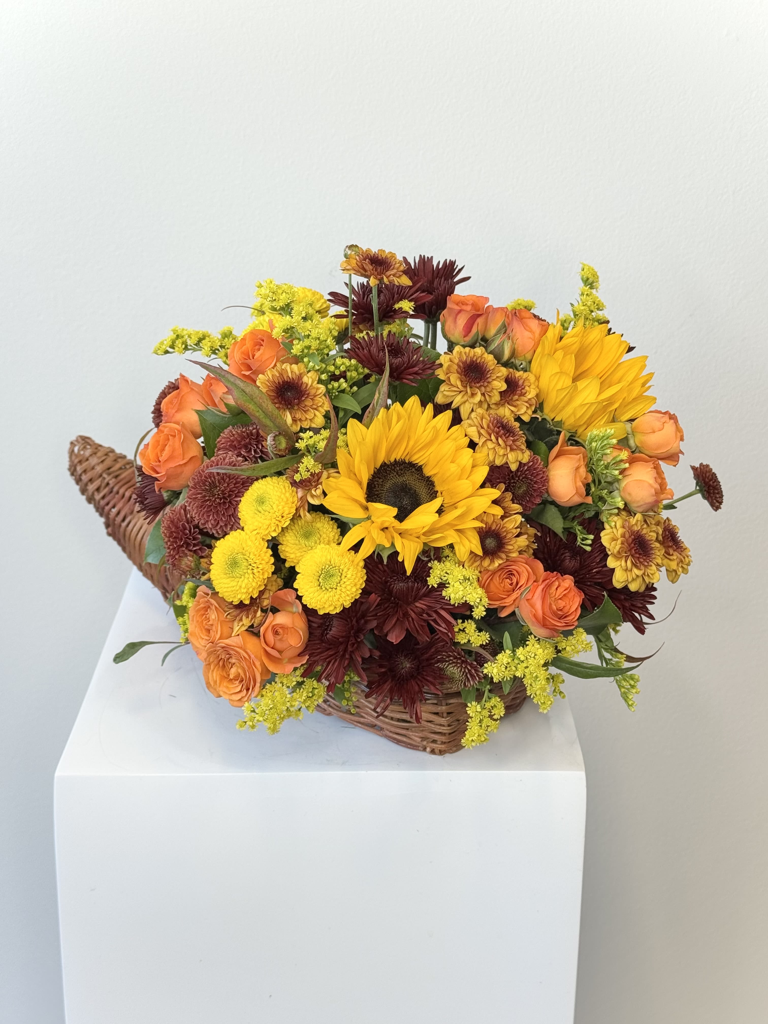 Basket arrangement with sunflowers, orange roses, and chrysanthemums