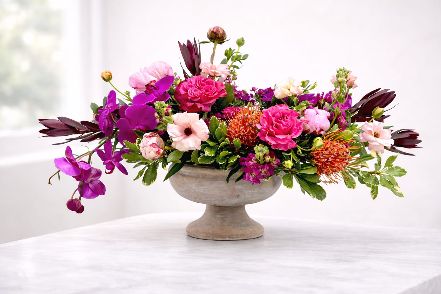 Dragonfly Duchess - A vibrant, luxurious, premium garden style arrangement in the elegant winnie compote. 