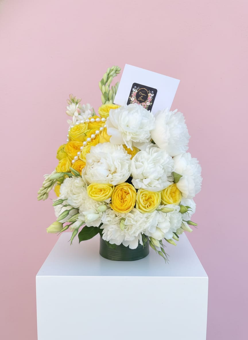 Pearly whites -  Graceful, refined, and impossibly elegant. A sleek, sophisticated white arrangement that embodies effortless luxury in every petal. Flower varieties and vessels may vary based on availability to ensure the highest quality.