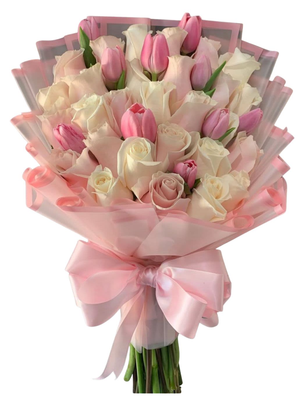 Pink tulips and pale roses wrapped in pink paper with a satin bow