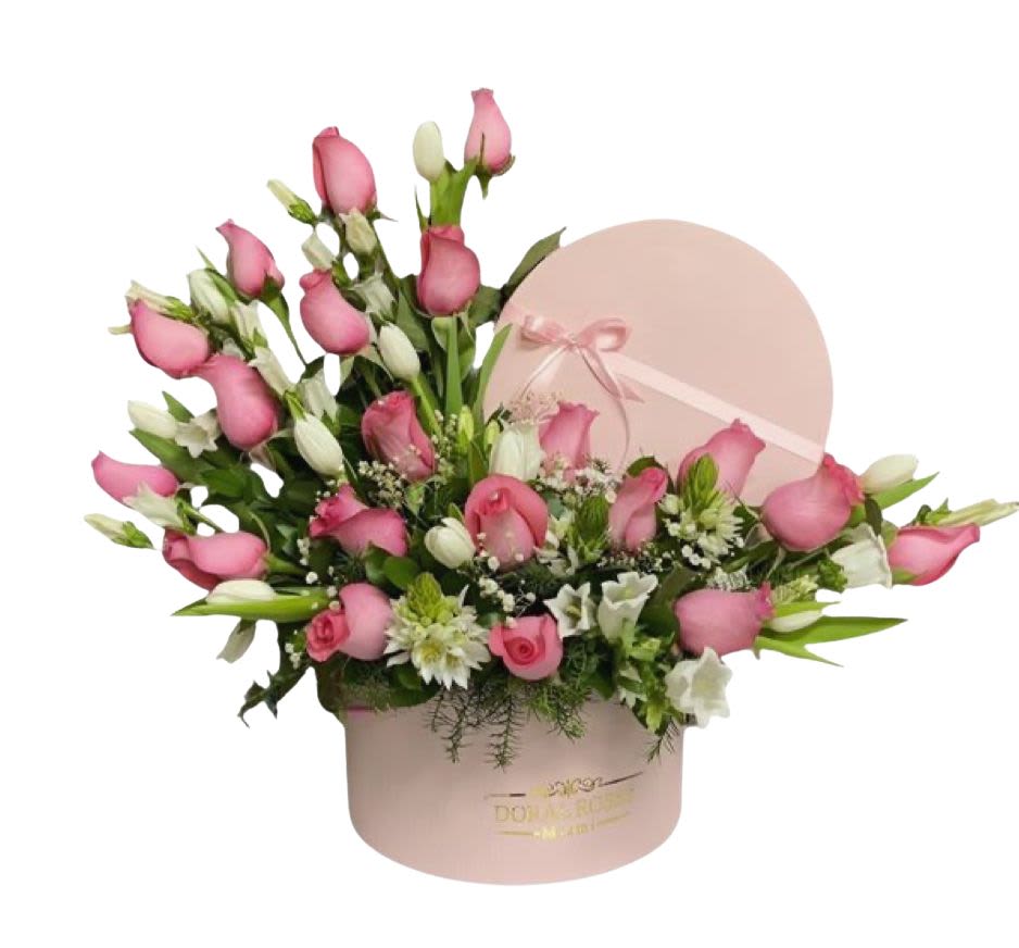 Pink roses and white flowers arranged in a round pink hat box
