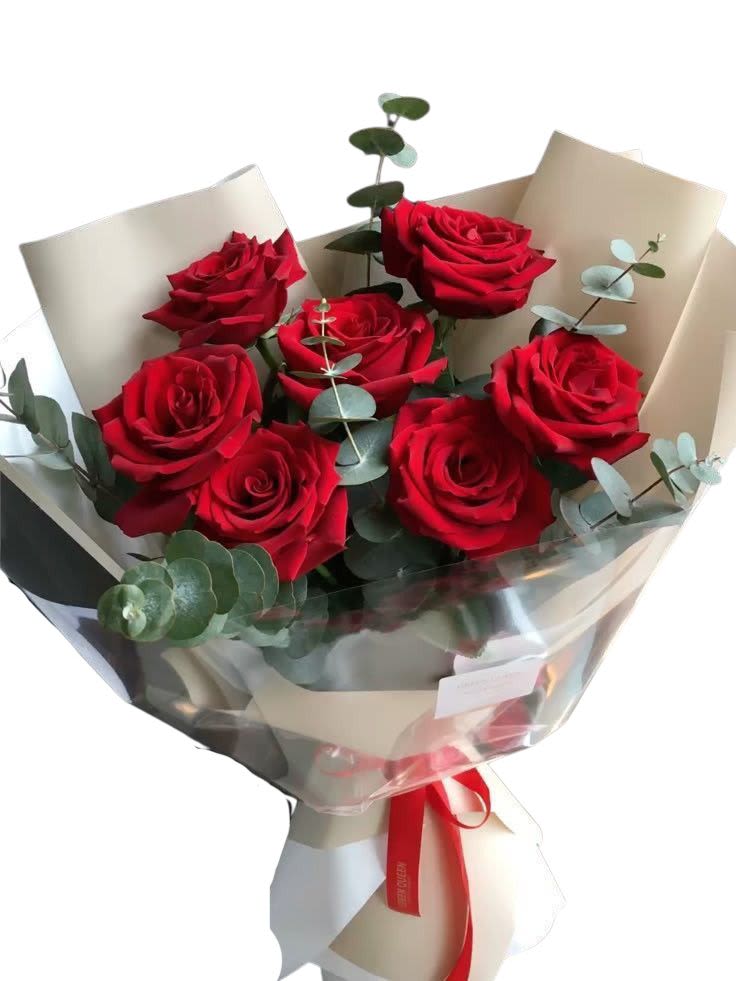 Bouquet of red roses wrapped in cream paper with eucalyptus