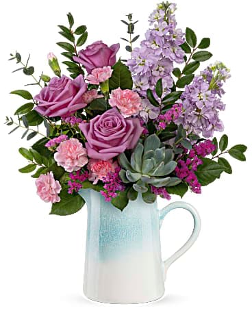 Teleflora's Farmhouse Chic Bouquet - This country-inspired surprise is sure to brighten Mother's Day--or any day!--with its lush lavender blooms and chic stoneware pitcher with ombre glaze. Lavender roses, lavender stock, miniature pink carnations, raspberry sinuata statice and a potted echeveria succulent are arranged with parvifolia eucalyptus and huckleberry. Delivered in Teleflora's Farmhouse Chic Pitcher.