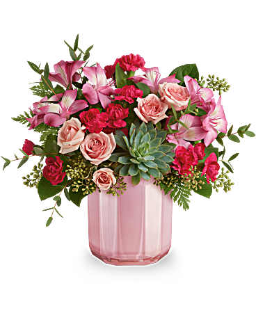 Teleflora's Rosy Radiance Bouquet - Brighten their day with this fabulous Valentine's Day bouquet, featuring a lovely succulent, all elegantly arranged in a pink glass vase with a chic sculpted design and pearlescent finish. This lovely Valentine's Day arrangement showcases an all-pink look with spray roses, alstroemeria, and miniature carnations, beautifully complemented by a succulent, parvifolia eucalyptus, seeded eucalyptus, leatherleaf fern, and lemon leaf. It's delivered in a Blushing Gem vase.