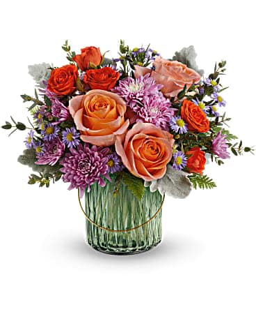 Teleflora's Pretty Blossoms Bouquet - Bursting with pretty blossoms today, glowing with a votive candle later, this delightful sage green glass lantern is a glorious gift. Peach roses, orange spray roses, lavender cushion spray chrysanthemums and small lavender monte cassino asters are accented with dusty miller, parvifolia eucalyptus and leatherleaf fern. Delivered in a Lush Garden Lantern.