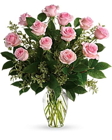 Say Something Sweet Bouquet - Say it sweeter with this feminine bouquet of a dozen ballet pink roses and lush greens in a graceful glass vase. 12 pink roses are arranged with pitta negra and lemon leaf. Delivered in a clear glass vase.