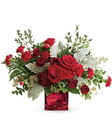 Rich In Love Bouquet by Teleflora - Unforgettable in every sense of the word! Make a dramatic impression with this ultrachic arrangement, featuring a modern organic shape, luxurious blooms, and a shimmering keepsake cube vase. This dramatic bouquet features red roses, dark red spray roses, maroon carnations, red miniature carnations, dusty miller, leatherleaf fern, huckleberry, seeded eucalyptus, lemon leaf, and parvifolia eucalyptus. Delivered in a Red Mirrored Cube.