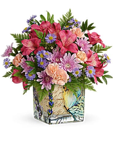Teleflora's Sophisticated Whimsy Bouquet - High-flying style for Mother's Day or any special occasion! Surprise them on their special day with the whimsical charm of this vintage-inspired butterfly vase bursting with bright blooms. Dark pink alstroemeria, miniature pink carnations, small purple monte cassino asters and lavender cushion spray chrysanthemums are arranged with huckleberry and leatherleaf fern. Delivered in the Vintage Butterfly Cube.
