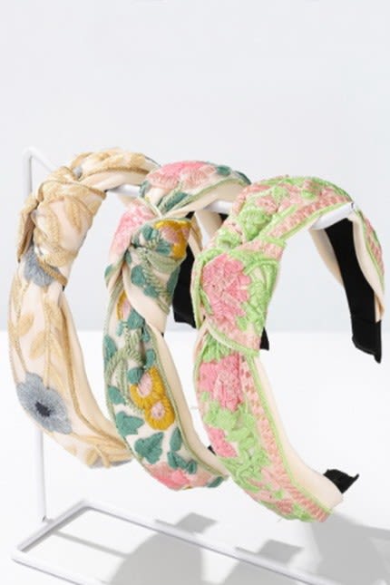 Floral Headband  - A vintage charm with this floral embroidery headband. Featuring delicate stitched floral patterns, this headband adds a touch of whimsy and romance to any outfit.   DIMENSION length:  6" width: 5" knot:  1"  Color and design are dependent on availability. Contact the store for specific design during business hours.