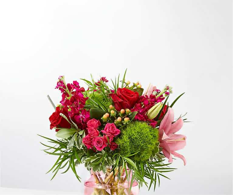 Bouquet of red and pink flowers in a glass vase