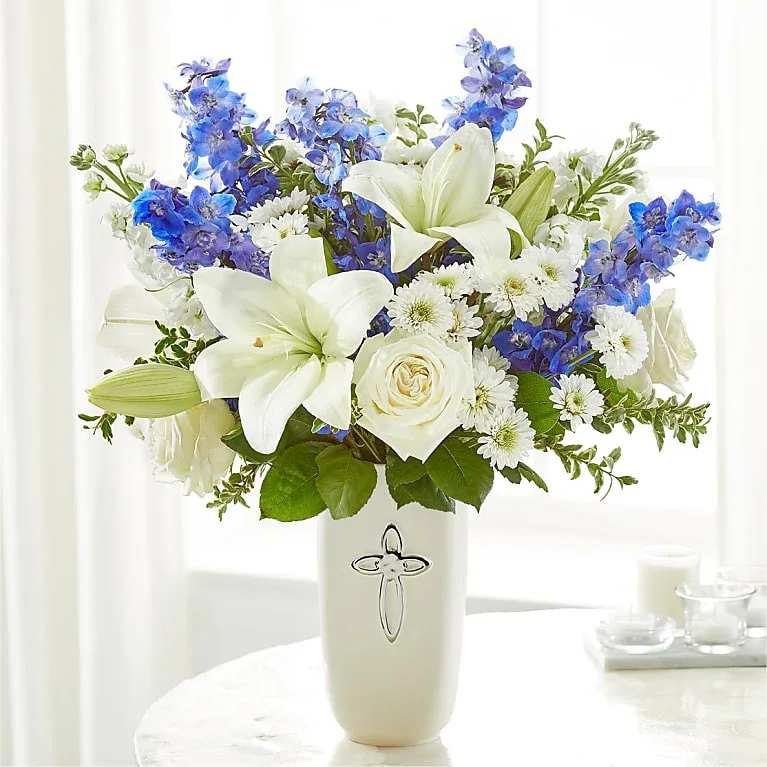 Cross Sympathy Arrangement - Heavenly blossoms indeed, this bouquet makes a beautiful gift to offer condolences or to honor a religious holiday. 