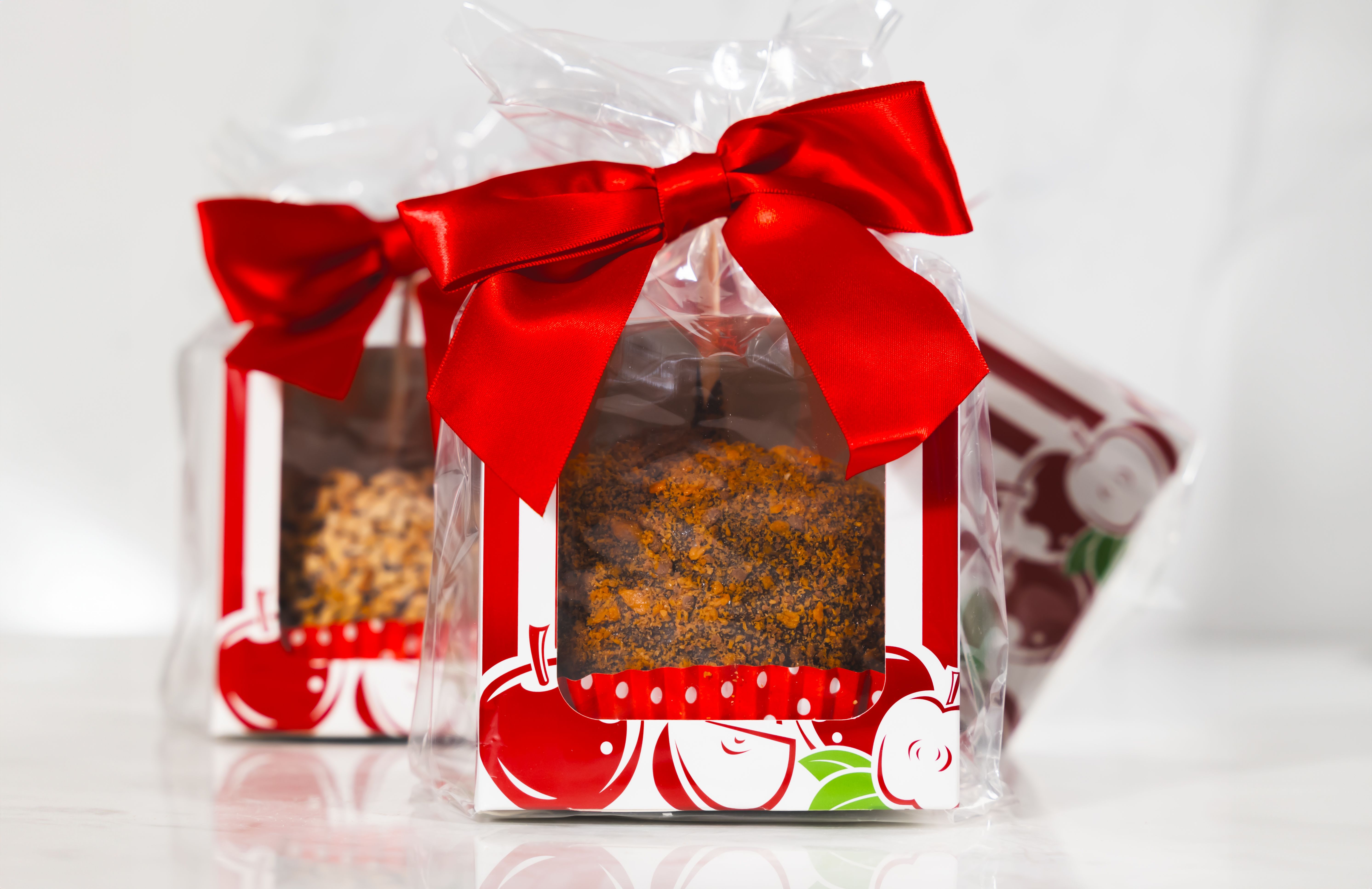 Gift boxes tied with red bows and wrapped in clear plastic