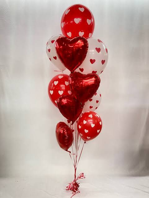Cluster of red and white heart-shaped balloons tied together