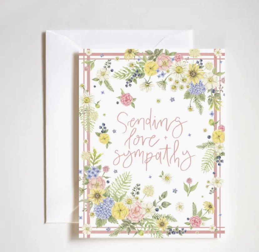 Sympathy card with pastel floral border and matching envelope