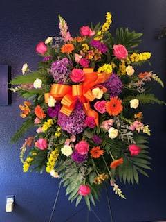 Celebration of Life - Beautiful, large funeral arrangement featuring seasonal flowers and vibrant colors