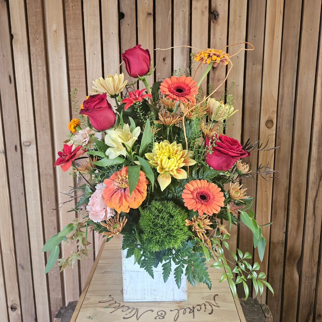 Mixed bouquet of roses, gerbera daisies, and chrysanthemums in a white box