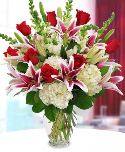 ROSES, HYDRANGEA, LILIES - A tall and elegant arrangement of all red blooms such as roses and white hydrangea accented with white Snapdragon and Oriental Lilies. Hand-delivered with a personalized gift message