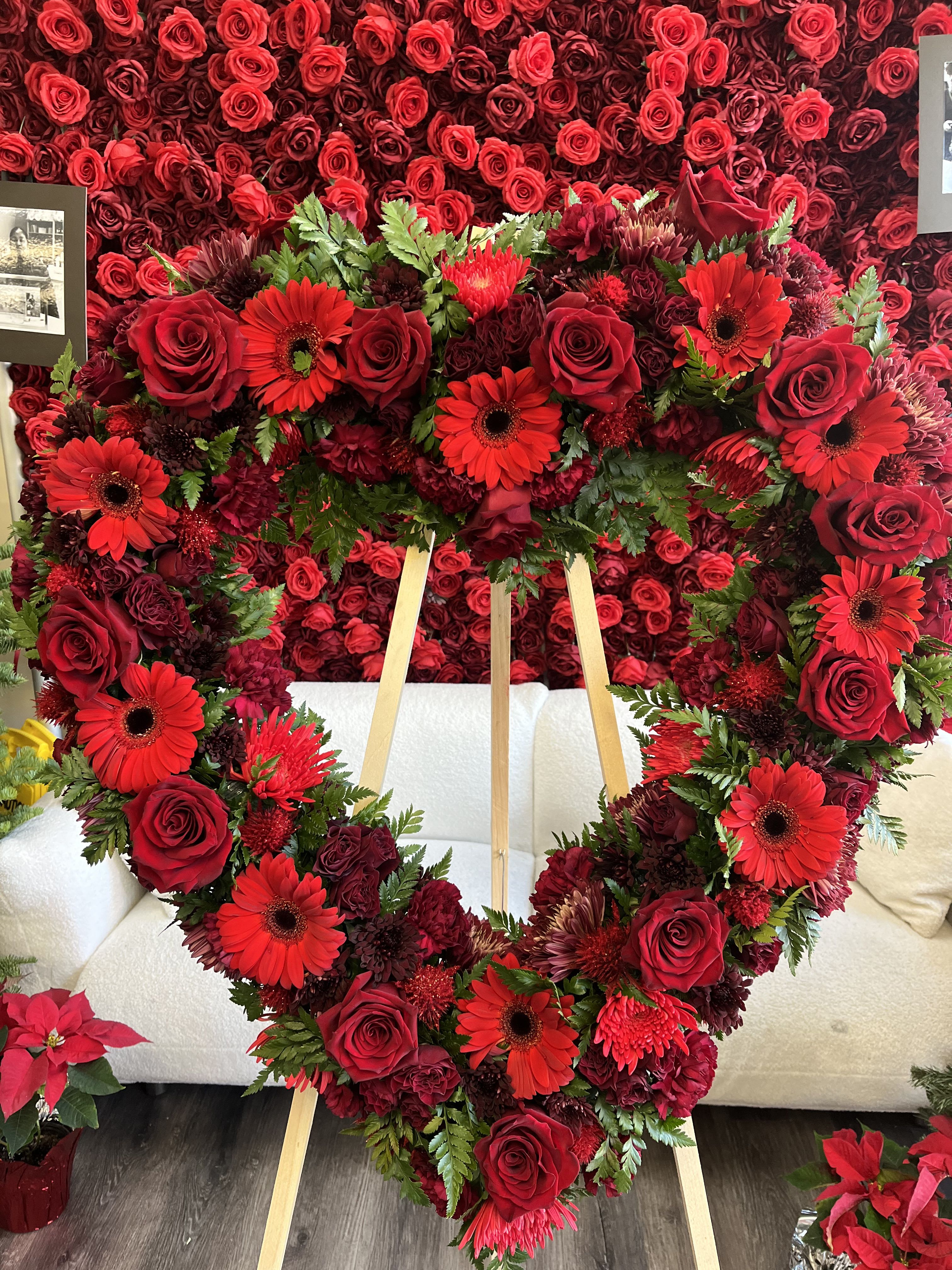 Red Sympathy Heart Wreath - Red Sympathy Heart Wreath is a heartfelt tribute designed to express warmth, love, and deep sympathy during life’s most difficult moments. **Note: PICTURED IS THE PREMIUM SIZE.  Easel is INCLUDED** Available In 21" (standard) and 28" (Premium)