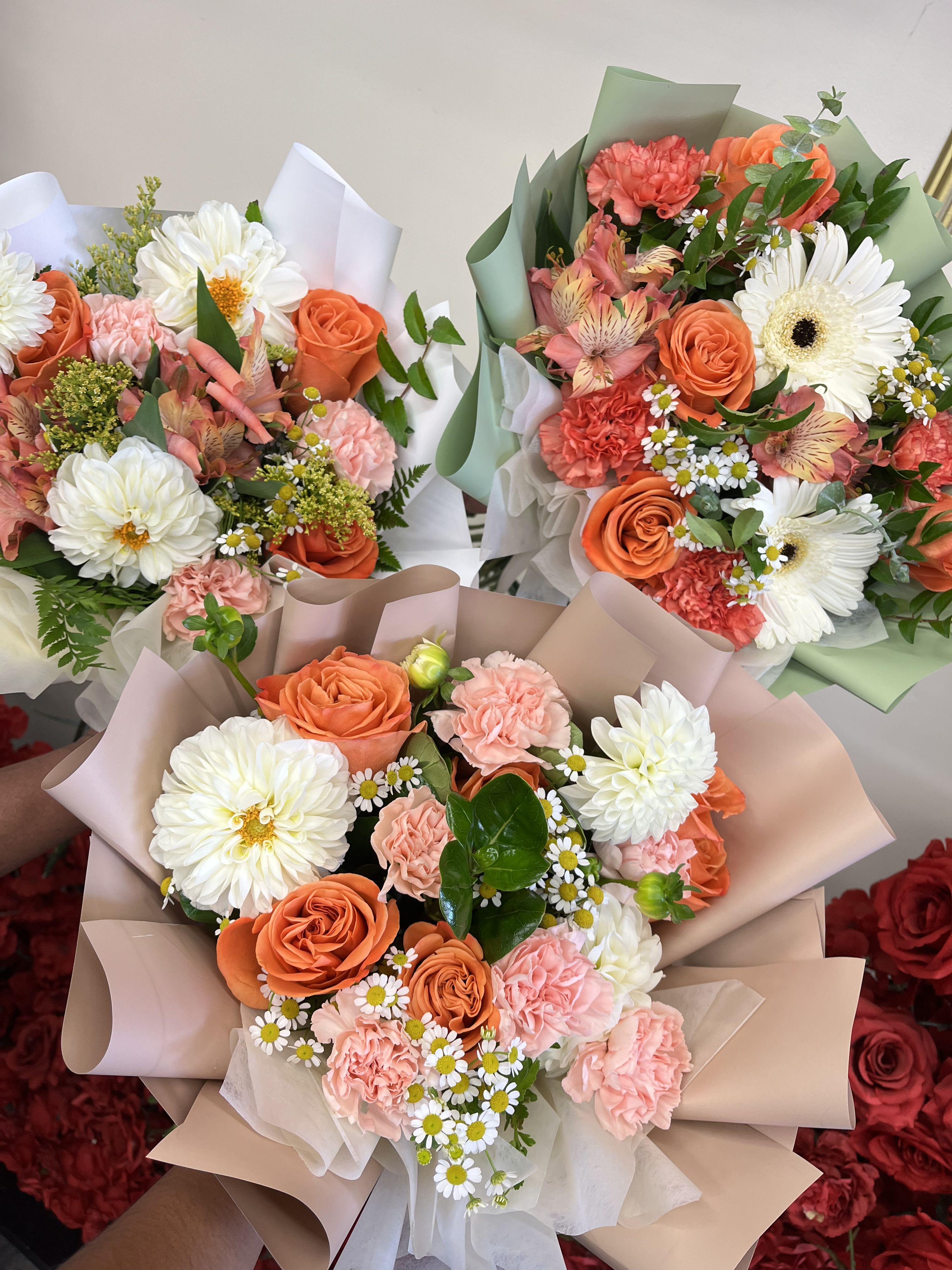 Florist Choice- Orange and Whites Wrapped Bqt - A bright and refreshing hand-wrapped bouquet designed with a seasonal mix of Orange and Whites blooms. Each arrangement is florist’s choice, meaning we select the freshest flowers available to create a balanced, vibrant look. Wrapped in our signature style, this bouquet is perfect for birthdays, celebrations, or simply to brighten someone’s day. Flower varieties may vary, but the color palette will remain true to Orange and White tones.