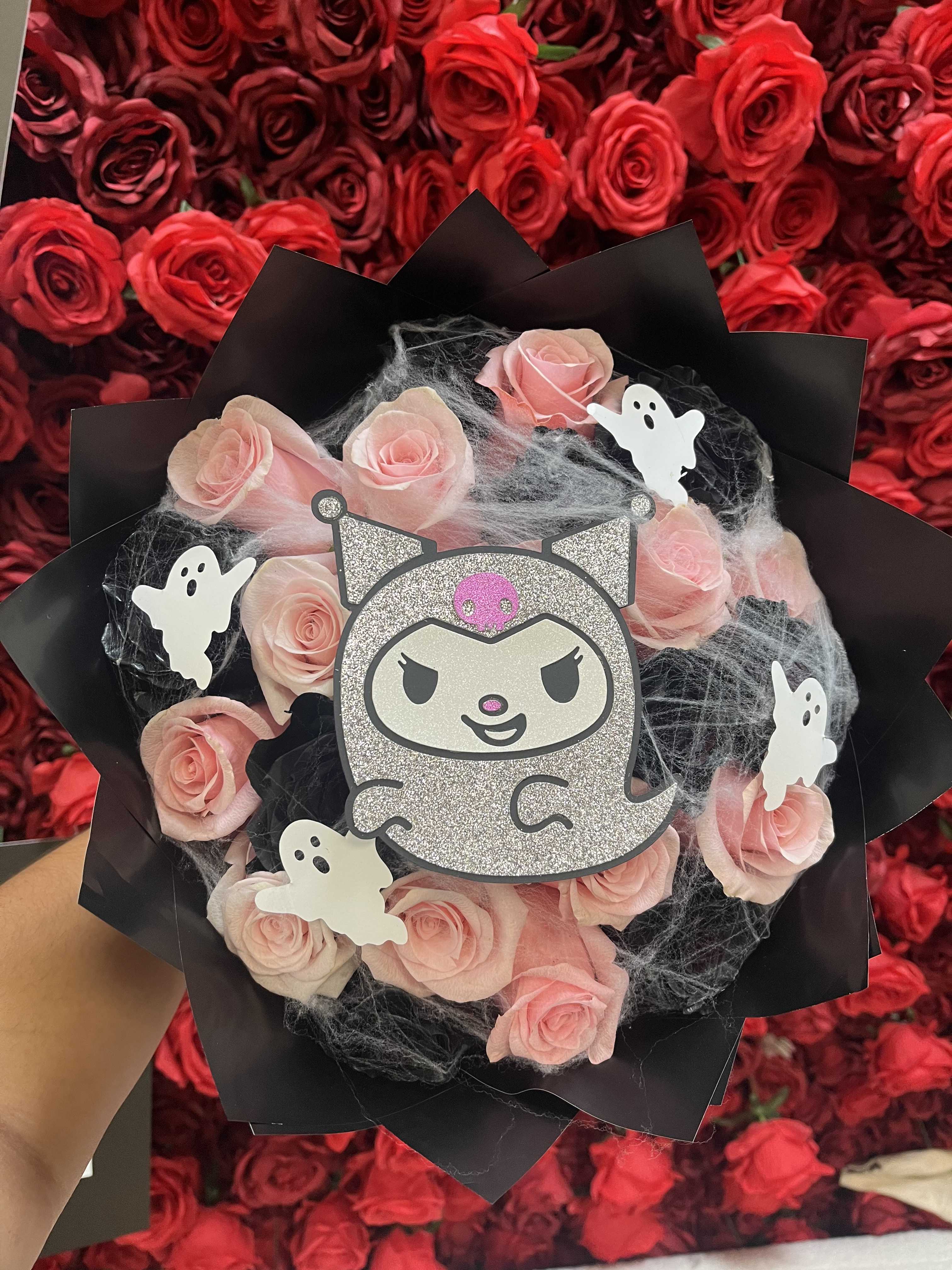 Pink rose bouquet with Halloween ghost decorations and a glitter cat topper