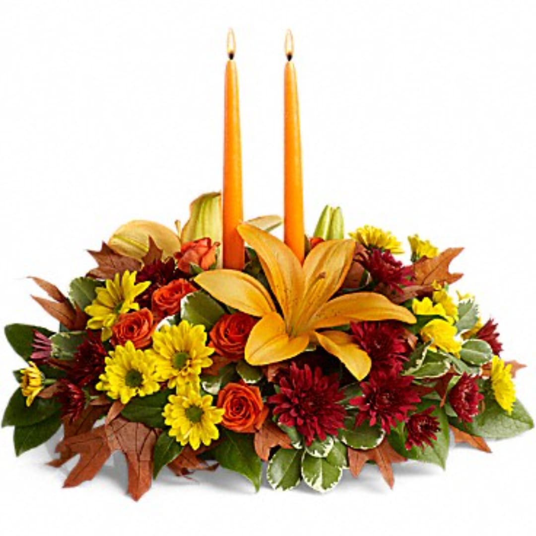 Autumn floral centerpiece with two orange candles