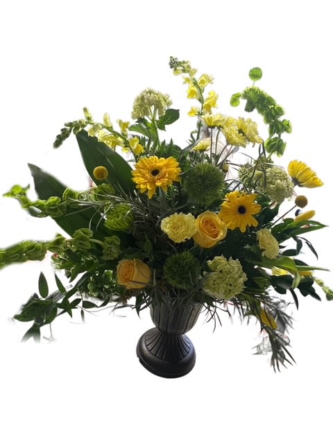 Yellow and green floral arrangement in a dark urn vase
