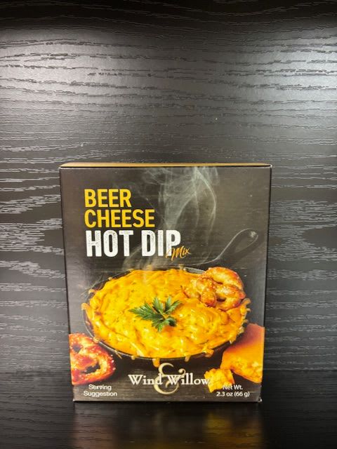 Box of beer cheese hot dip mix on a dark wood surface
