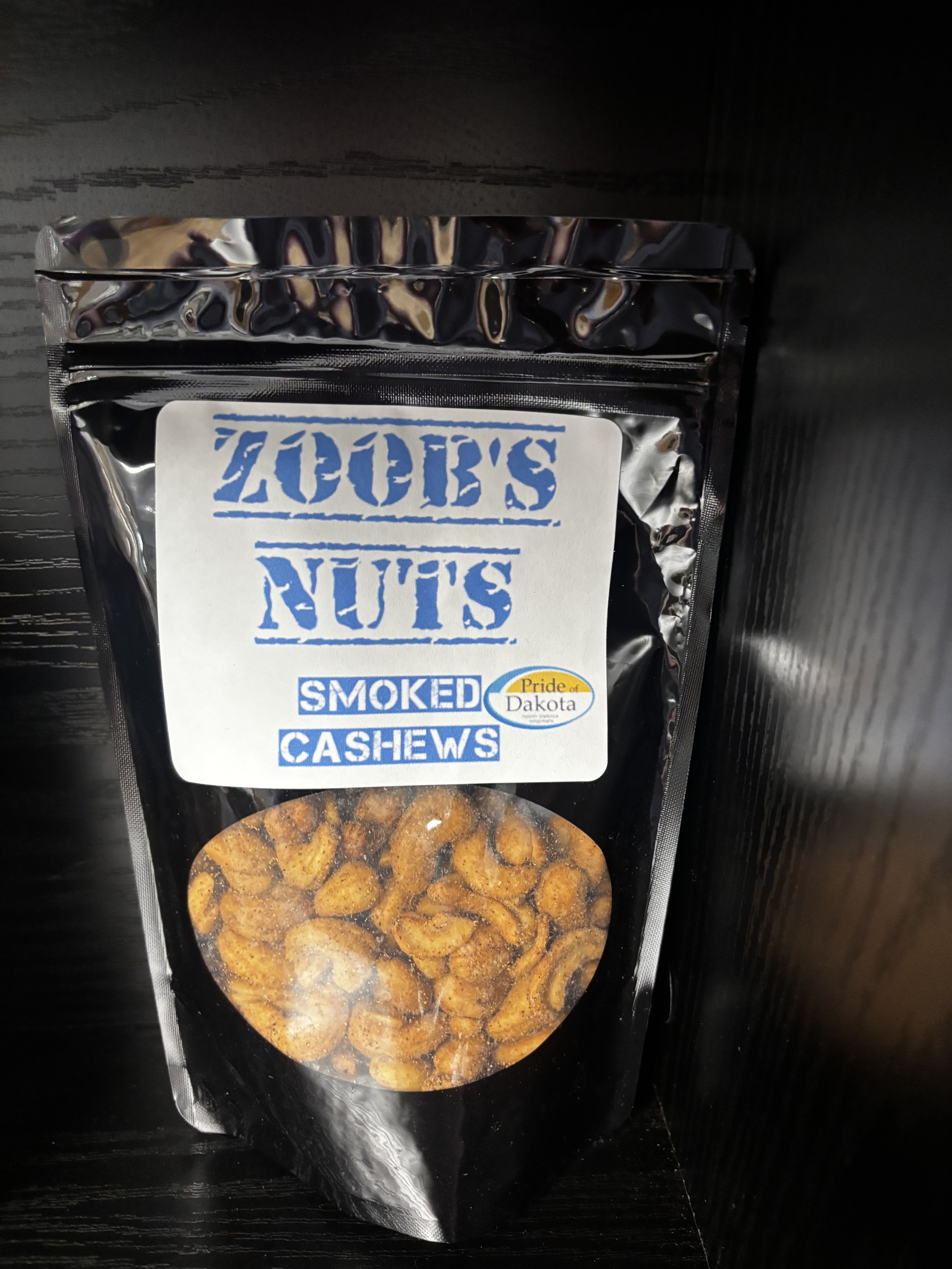 Bag of smoked cashews with a clear window and blue label