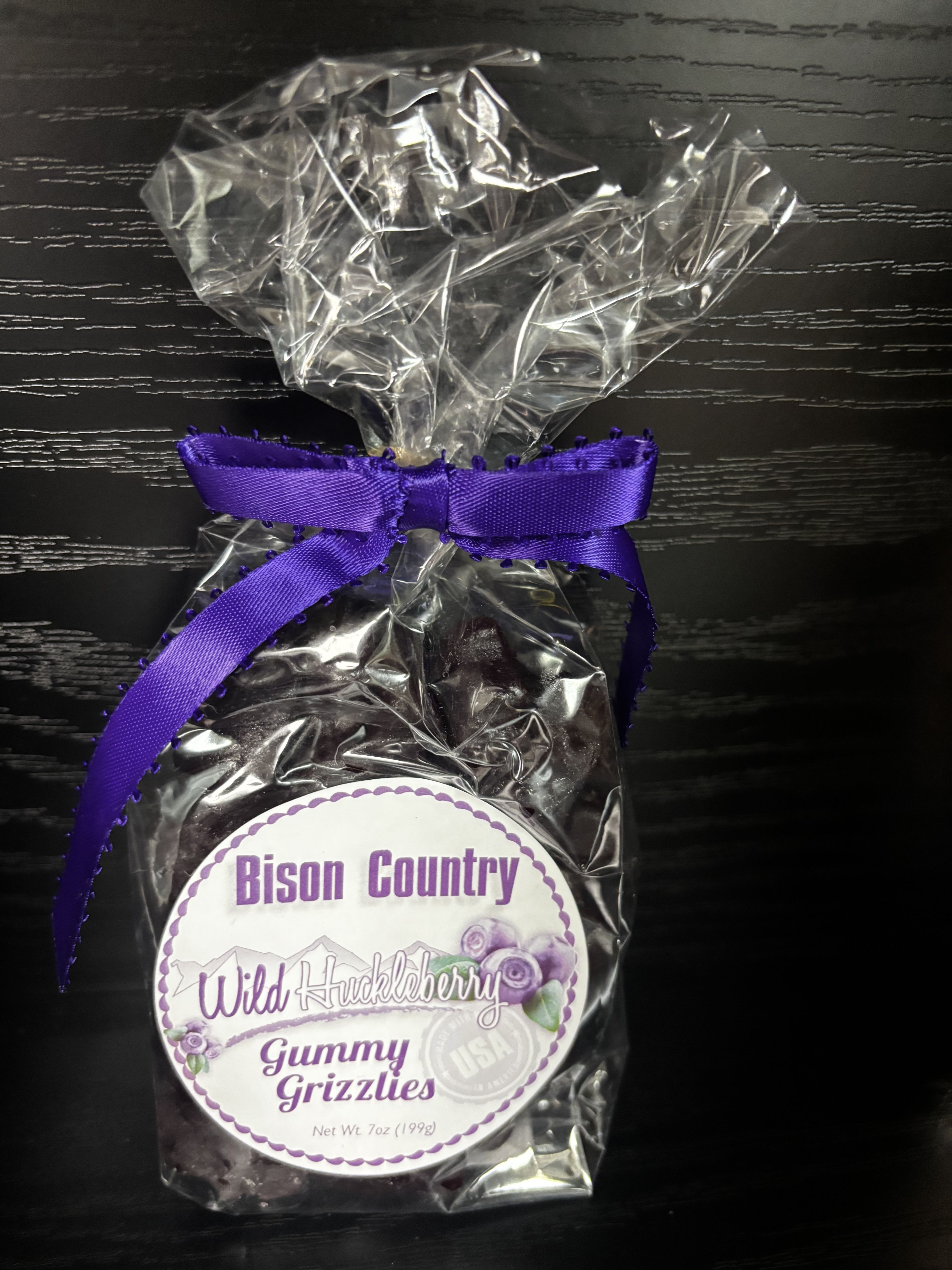 Bag of wild huckleberry gummy candies tied with a purple ribbon